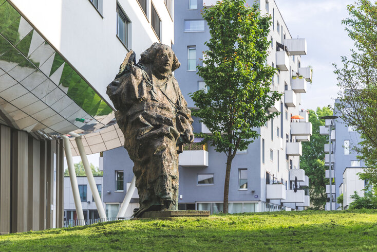 Paracelsus Statue im Grünen im Frühling am PMU Campus in Salzburg